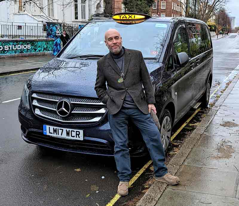 Standing by his London Black Cab.